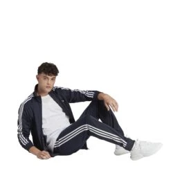 Adidas Sportswear Basic 3-Streifen Tricot Trainingsanzug 10680741 29 Adidas Sportswear Basic 3-Streifen Tricot Trainingsanzug 10680741 -Woehrl Populaire Boutique HZ2220 7 APPAREL On Model Walking View transparent