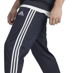 Adidas Sportswear Basic 3-Streifen Tricot Trainingsanzug 10680741 32 Adidas Sportswear Basic 3-Streifen Tricot Trainingsanzug 10680741 -Woehrl Populaire Boutique HZ2220 9 APPAREL On Model Detail View 2 transparent